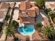 Overhead view of a house featuring a kidney shaped pool, patio, desert landscaping, and mature trees at 1587 Bermuda Dunes Dr, Boulder City, NV 89005