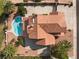 Stunning aerial view of a house featuring a backyard pool, spacious patio, and a terracotta-tiled roof at 1587 Bermuda Dunes Dr, Boulder City, NV 89005