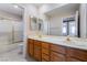 Bathroom with a double sink vanity, large mirror, bathtub, and shower, perfect for relaxation at 1587 Bermuda Dunes Dr, Boulder City, NV 89005