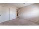 Bright bedroom featuring neutral carpet, closet, and an open doorway, creating a calm space at 1587 Bermuda Dunes Dr, Boulder City, NV 89005