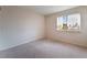 Empty bedroom with neutral carpet, natural light, and white curtains at 1587 Bermuda Dunes Dr, Boulder City, NV 89005