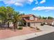 Charming two-story home with a three-car garage, mature trees, and meticulous landscaping at 1587 Bermuda Dunes Dr, Boulder City, NV 89005