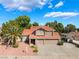 Attractive two-story home featuring a three-car garage and mature trees at 1587 Bermuda Dunes Dr, Boulder City, NV 89005
