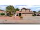 Two-story home featuring a terracotta roof, desert landscaping, and a two-car garage at 1587 Bermuda Dunes Dr, Boulder City, NV 89005