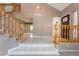 Spacious tiled foyer featuring a staircase, large windows, and a view into the living area at 1587 Bermuda Dunes Dr, Boulder City, NV 89005