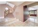 Bright foyer featuring tile floors, staircase, and entry to the living room with large windows at 1587 Bermuda Dunes Dr, Boulder City, NV 89005