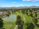 Expansive view of a golf course with a serene pond, mature trees, and manicured green fairways at 1587 Bermuda Dunes Dr, Boulder City, NV 89005