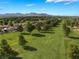 Picturesque view of a golf course surrounded by trees and homes with a mountain range in the distance at 1587 Bermuda Dunes Dr, Boulder City, NV 89005