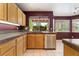 Well-lit kitchen featuring stainless steel appliances, wooden cabinets, and a window above the sink at 1587 Bermuda Dunes Dr, Boulder City, NV 89005