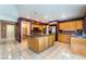 Spacious kitchen with tile flooring, wood cabinetry, stainless appliances, and center island at 1587 Bermuda Dunes Dr, Boulder City, NV 89005