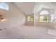 Bright living room with vaulted ceilings, large windows, and neutral-colored walls at 1587 Bermuda Dunes Dr, Boulder City, NV 89005
