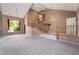 Open living room with vaulted ceilings, a staircase, and large windows offering ample natural light at 1587 Bermuda Dunes Dr, Boulder City, NV 89005