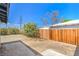 Spacious backyard featuring a concrete patio, fresh wood fence and lush greenery at 1600 E Mcdonald Ave, North Las Vegas, NV 89030