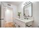 Bathroom featuring a modern vanity with framed mirror, new fixtures, and wood-look floors at 1600 E Mcdonald Ave, North Las Vegas, NV 89030