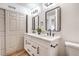 Bathroom featuring double sinks, stone countertop, modern mirrors, and a toilet at 1600 E Mcdonald Ave, North Las Vegas, NV 89030