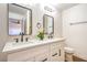 Bathroom with a double vanity, stone countertop, black faucets, and modern mirrors at 1600 E Mcdonald Ave, North Las Vegas, NV 89030