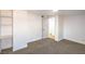 Bright bedroom featuring neutral carpet, a door to the bathroom, and custom built-in shelving at 1600 E Mcdonald Ave, North Las Vegas, NV 89030