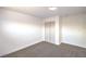 Bedroom featuring neutral carpet, white walls and trim, and a large closet at 1600 E Mcdonald Ave, North Las Vegas, NV 89030