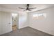 Bright bedroom with fresh carpet, ceiling fan and adjacent bathroom with vanity at 1600 E Mcdonald Ave, North Las Vegas, NV 89030