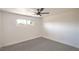 Bright bedroom featuring neutral carpet, fresh white paint, and ample natural light at 1600 E Mcdonald Ave, North Las Vegas, NV 89030