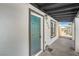 View of the front entrance showing the teal front door and modern exterior lighting at 1600 E Mcdonald Ave, North Las Vegas, NV 89030
