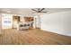 An open concept kitchen with bar stool seating, stainless steel appliances, and light wood flooring at 1600 E Mcdonald Ave, North Las Vegas, NV 89030