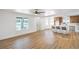 Bright, open-concept living space with light wood floors and a view of the kitchen at 1600 E Mcdonald Ave, North Las Vegas, NV 89030