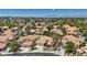 Aerial view of a home and neighborhood with tile roofs, swimming pools, and mountain views at 175 Palta Ct, Henderson, NV 89074