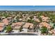 Aerial view of a home and neighborhood with tile roofs, swimming pools, and mountain views at 175 Palta Ct, Henderson, NV 89074
