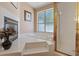 Relaxing bathroom with a garden tub, glass-enclosed shower, and a decorative fireplace insert at 175 Palta Ct, Henderson, NV 89074