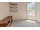 Bright bedroom with carpet, a display cabinet, floating shelves, and a window providing ample natural light at 175 Palta Ct, Henderson, NV 89074