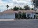 Charming single-story home featuring a three-car garage, well-manicured landscaping, and a classic tile roof at 175 Palta Ct, Henderson, NV 89074
