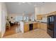 Well-lit kitchen with tile flooring, stainless steel appliances, and seamless flow to living area at 175 Palta Ct, Henderson, NV 89074