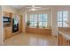 Bright kitchen features wooden cabinets, tile flooring, a ceiling fan, and a window with wooden shutters and planters at 175 Palta Ct, Henderson, NV 89074