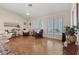 Spacious living area with hardwood floors, plantation shutters, and sliding glass doors to backyard at 175 Palta Ct, Henderson, NV 89074