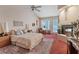 Serene main bedroom with a fireplace, vaulted ceilings, carpet, and a private door to the outside at 175 Palta Ct, Henderson, NV 89074