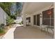 Covered patio with white pillars, concrete floor, chairs, and a view of the garden pathway at 175 Palta Ct, Henderson, NV 89074