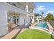 Beautiful backyard showcasing a covered patio, dining area, refreshing pool and manicured landscaping at 1990 Country Cove Ct, Las Vegas, NV 89135