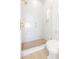 Bathroom featuring a shower with glass doors, white tile, and gold fixtures at 1990 Country Cove Ct, Las Vegas, NV 89135