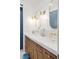 Bathroom features a dual sink vanity with gold fixtures and a wood cabinet at 1990 Country Cove Ct, Las Vegas, NV 89135