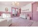 Bedroom with pink accents features a decorative name art, a crib, and French doors at 1990 Country Cove Ct, Las Vegas, NV 89135