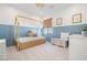 Charming bedroom with light blue paneling, framed prints, and a canopy style bed at 1990 Country Cove Ct, Las Vegas, NV 89135