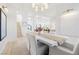 Bright dining room boasts a modern chandelier, hardwood floors, and neutral color palette at 1990 Country Cove Ct, Las Vegas, NV 89135