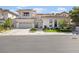 Stunning two-story home with a three-car garage, manicured lawn, and elegant facade at 1990 Country Cove Ct, Las Vegas, NV 89135