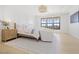 Main bedroom features a bed with a cushioned headboard, wood floors, and ample natural light at 1990 Country Cove Ct, Las Vegas, NV 89135