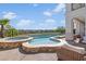 The backyard features a stunning pool and spa area with an outdoor lounge with comfortable seating for relaxation at 1990 Country Cove Ct, Las Vegas, NV 89135