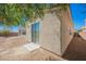 House with a desert landscaped backyard with sliding glass doors and small patio at 2008 Royal Gardens Pl, North Las Vegas, NV 89084