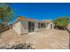 Backyard has desert landscaping with a sliding glass door and windows at 2008 Royal Gardens Pl, North Las Vegas, NV 89084