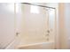 Bathroom with a tub and tiled shower with window at 2008 Royal Gardens Pl, North Las Vegas, NV 89084