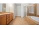 Bathroom featuring double sinks, a glass shower, and a soaking tub at 2008 Royal Gardens Pl, North Las Vegas, NV 89084